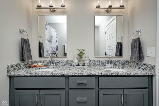 bathroom with vanity and a notable chandelier