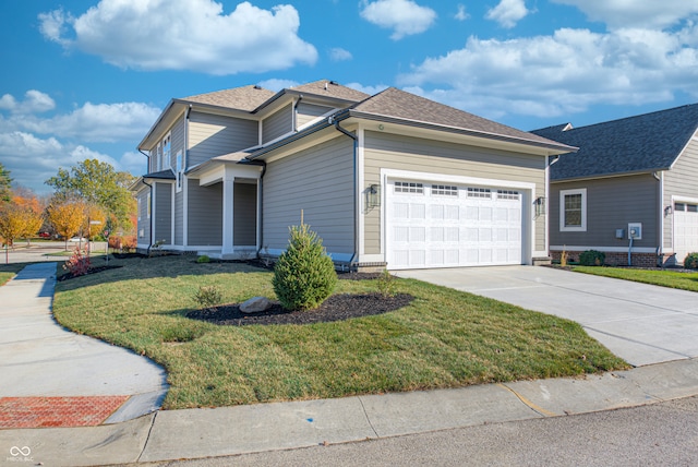 view of front facade featuring a front yard and a garage