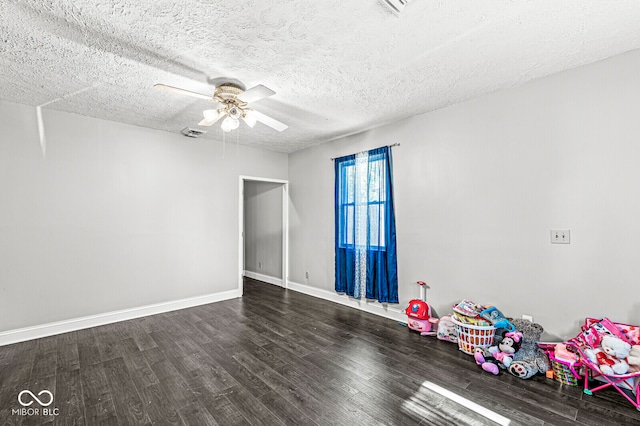 spare room featuring a textured ceiling, ceiling fan, and dark hardwood / wood-style flooring