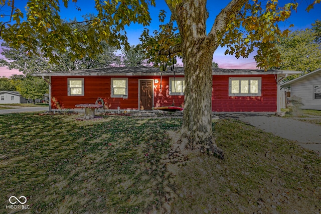 ranch-style home with a lawn