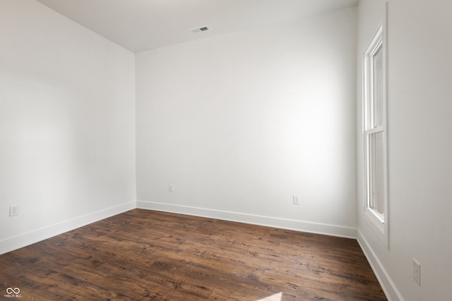 spare room featuring dark hardwood / wood-style flooring