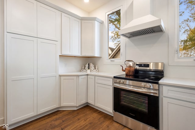 kitchen featuring custom range hood, stainless steel range oven, dark hardwood / wood-style floors, and white cabinets