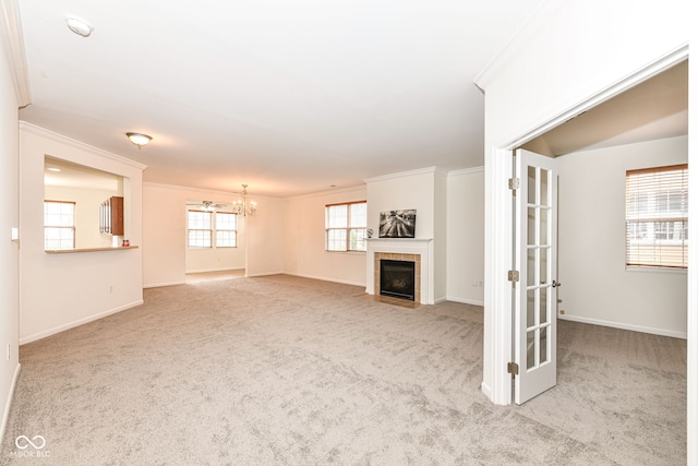 unfurnished living room featuring light colored carpet, crown molding, and a tiled fireplace