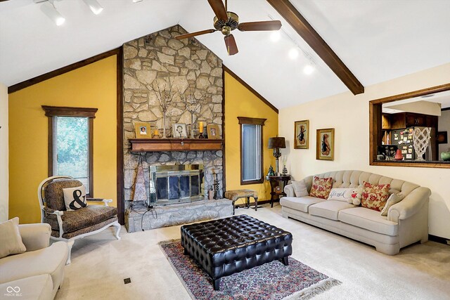 8530 Helmsman Cir, Indianapolis, IN 46256 - carpeted living room with a ceiling fan, a stone fireplace, beam ceiling, track lighting, and high vaulted ceiling
