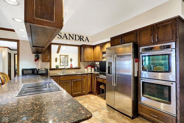 8530 Helmsman Cir, Indianapolis, IN 46256 - kitchen with black appliances, decorative backsplash, dark stone counters, recessed lighting, and a peninsula