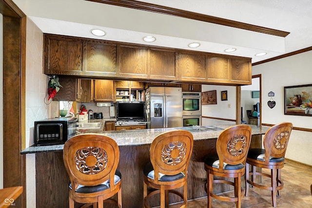 8530 Helmsman Cir, Indianapolis, IN 46256 - kitchen featuring ornamental molding, appliances with stainless steel finishes, a peninsula, recessed lighting, and tasteful backsplash