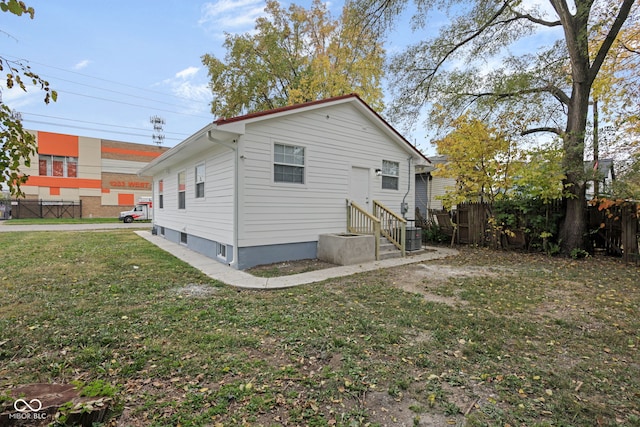 rear view of house featuring a lawn