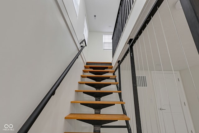 stairs featuring a towering ceiling