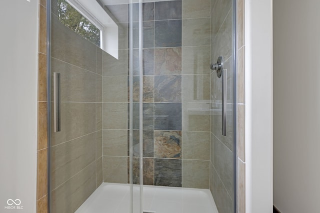 bathroom with a shower with door