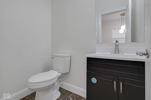 bathroom featuring vanity, toilet, and tile patterned flooring