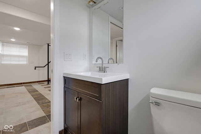 bathroom featuring vanity, toilet, and tile patterned floors