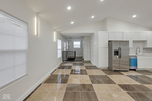 interior space featuring sink and lofted ceiling