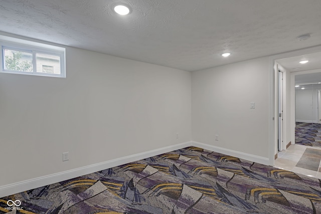 unfurnished room featuring a textured ceiling