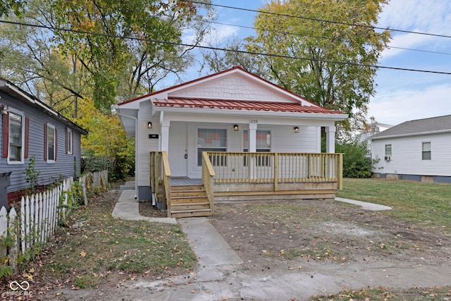 bungalow-style home with a front lawn and covered porch