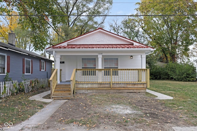 bungalow with a front yard and a porch