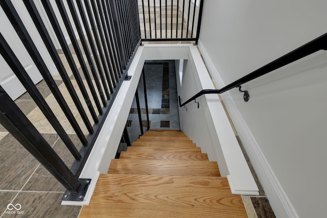 stairs featuring hardwood / wood-style flooring