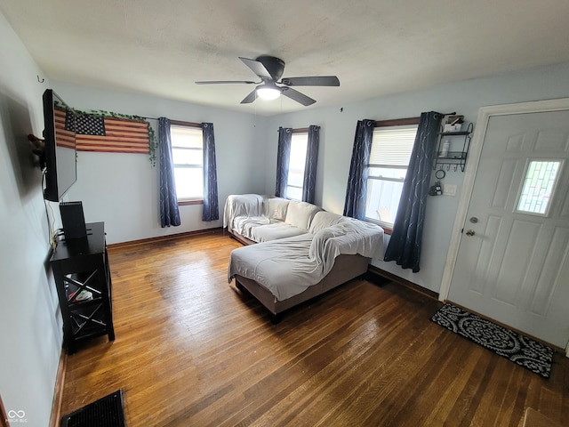 living room featuring wood-type flooring and ceiling fan