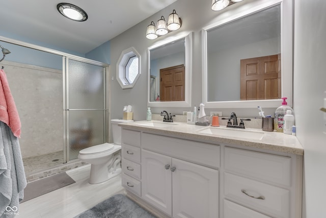 bathroom with vanity, toilet, hardwood / wood-style flooring, and walk in shower