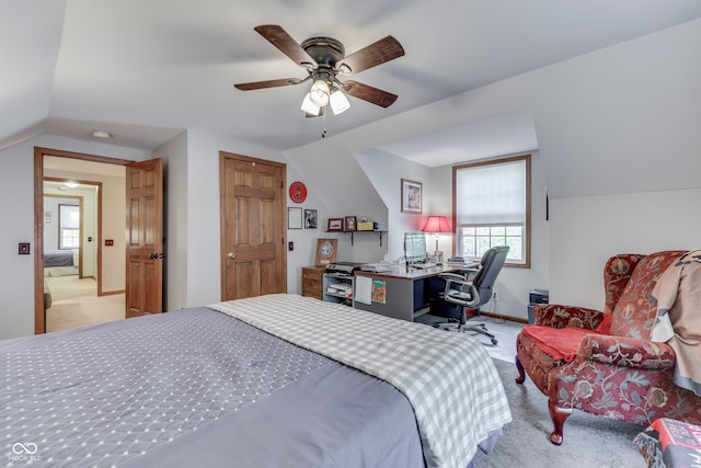 carpeted bedroom with ceiling fan and lofted ceiling