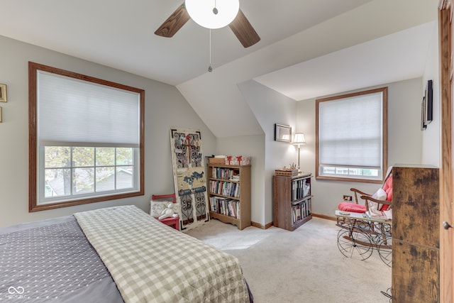 bedroom featuring light colored carpet, vaulted ceiling, and ceiling fan