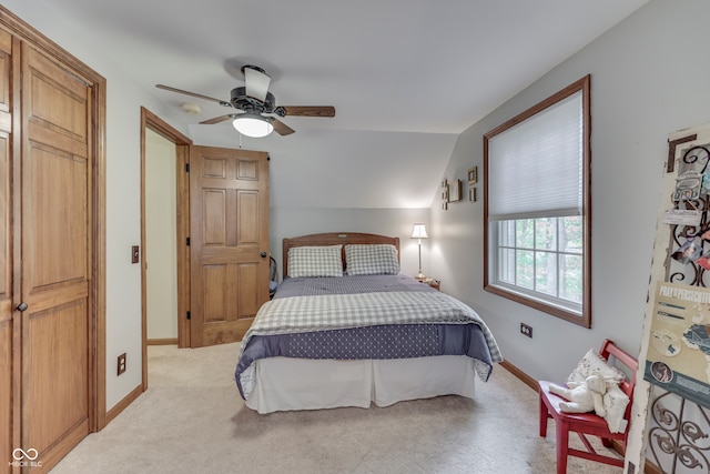 carpeted bedroom featuring vaulted ceiling and ceiling fan