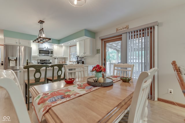 dining area featuring sink and light hardwood / wood-style floors