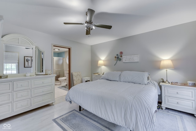 bedroom featuring connected bathroom, light hardwood / wood-style flooring, and ceiling fan