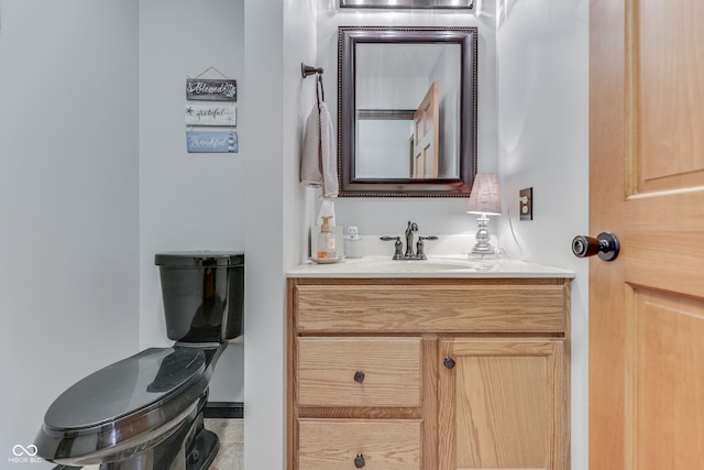 bathroom with vanity, toilet, and tile patterned flooring