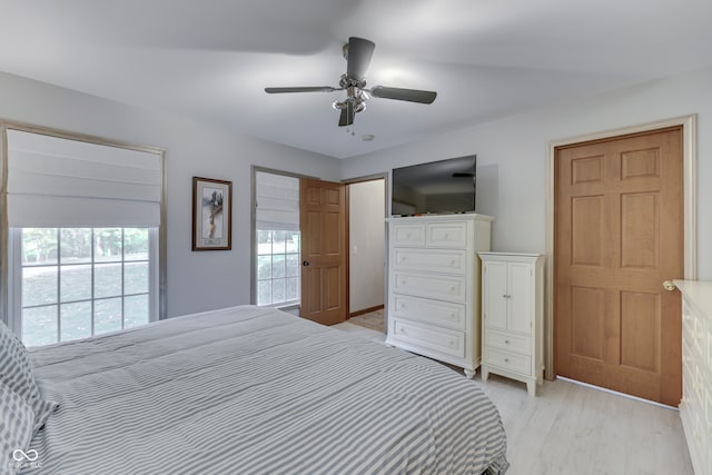 bedroom with ceiling fan and light hardwood / wood-style flooring