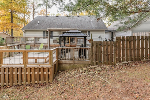 rear view of house with a gazebo and a deck