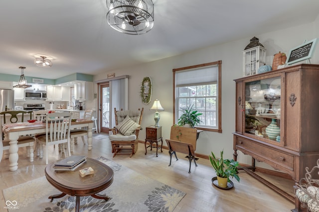 living room with light hardwood / wood-style floors and sink