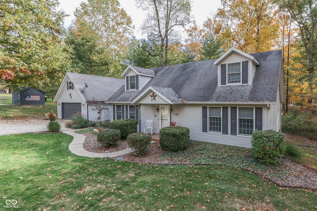 new england style home featuring a garage and a front lawn