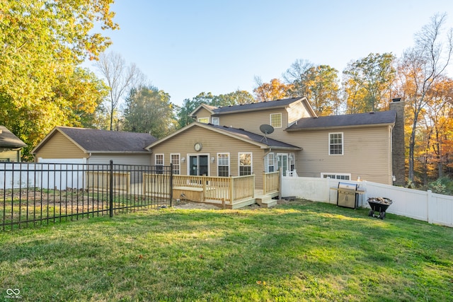 back of property with a yard and a deck