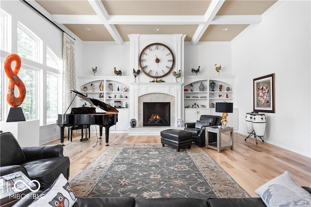 living room with a wealth of natural light, coffered ceiling, and light hardwood / wood-style floors