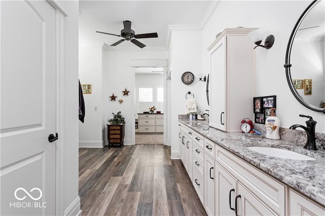 bathroom with vanity, ceiling fan, ornamental molding, and hardwood / wood-style floors