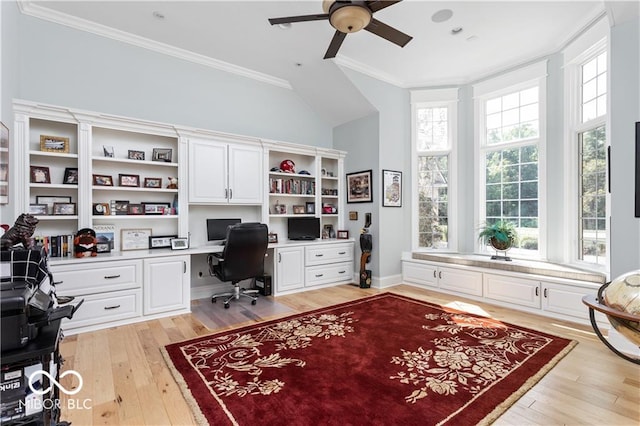 office space with built in desk, crown molding, light hardwood / wood-style floors, and ceiling fan