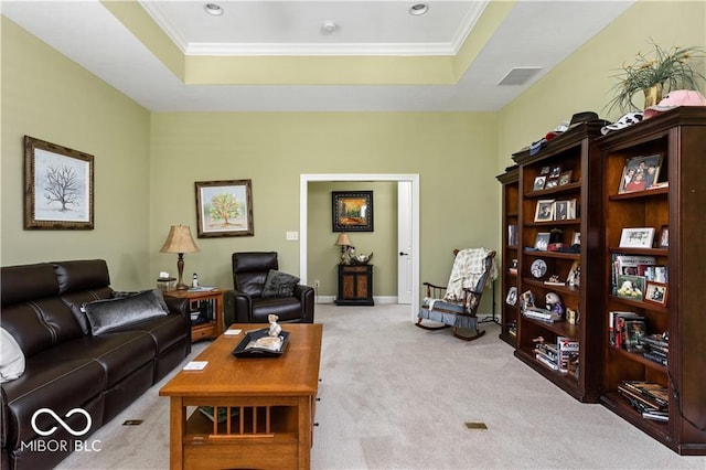 carpeted living room with crown molding and a raised ceiling