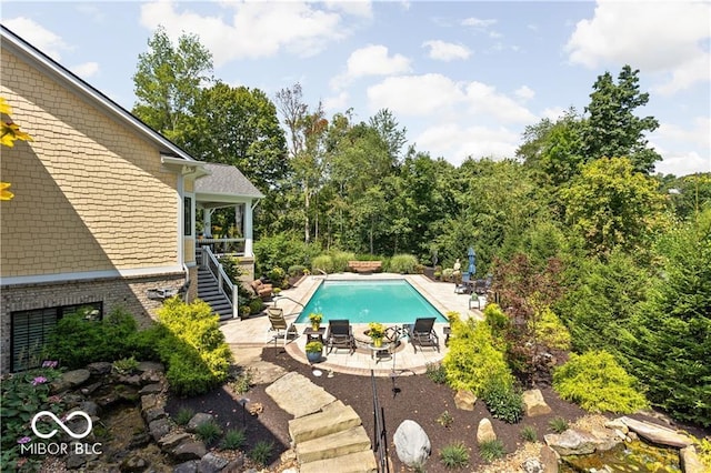 view of swimming pool with a patio