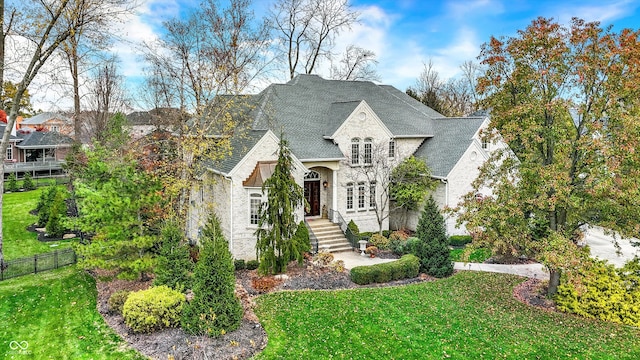 french country inspired facade featuring a front yard