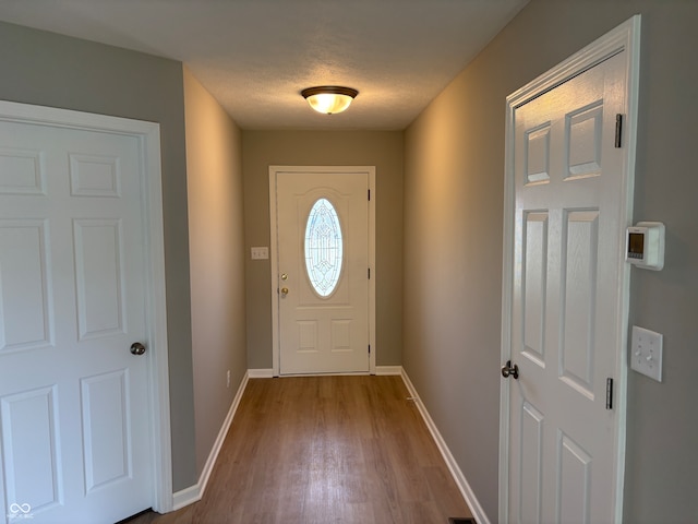 entryway with hardwood / wood-style floors and a textured ceiling