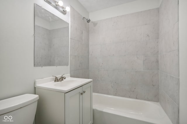 full bathroom featuring vanity, toilet, and tiled shower / bath