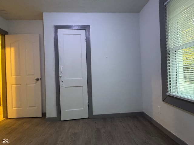 unfurnished bedroom featuring dark hardwood / wood-style flooring