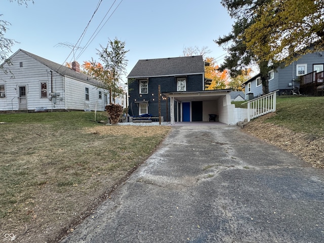 view of front of home with a front lawn and a carport