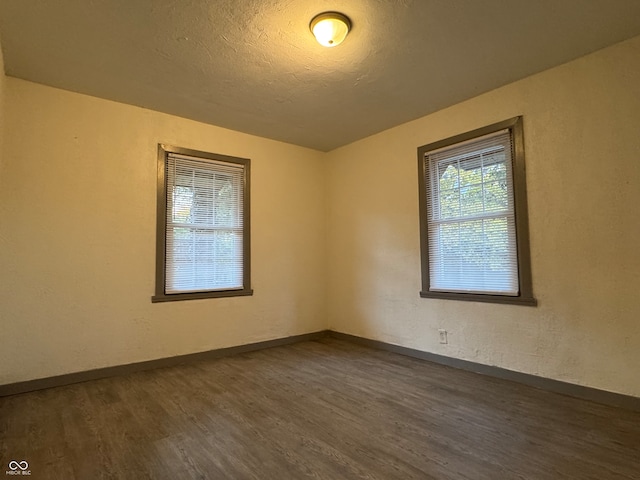 spare room featuring dark hardwood / wood-style floors