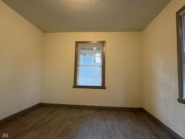 empty room with dark hardwood / wood-style floors