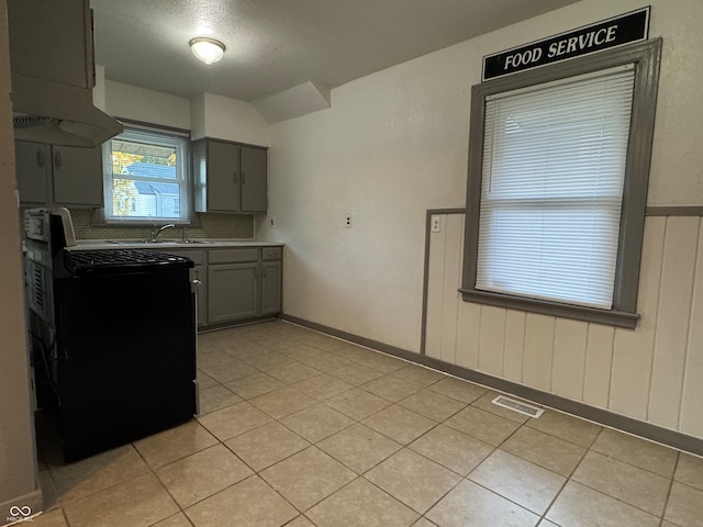 kitchen with gray cabinets, extractor fan, black range with electric stovetop, and light tile patterned floors