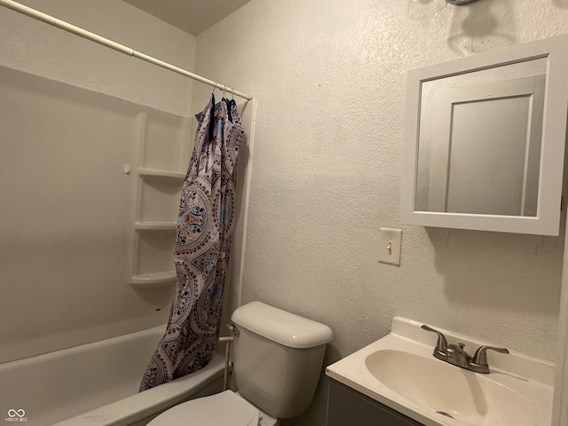 full bathroom with vanity, shower / tub combo, and toilet