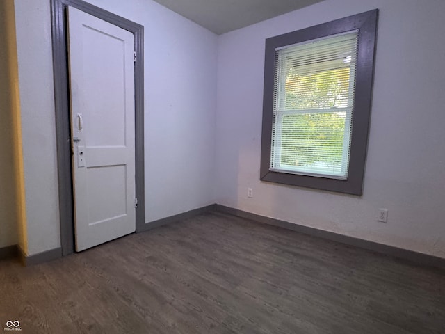 unfurnished room featuring dark hardwood / wood-style floors