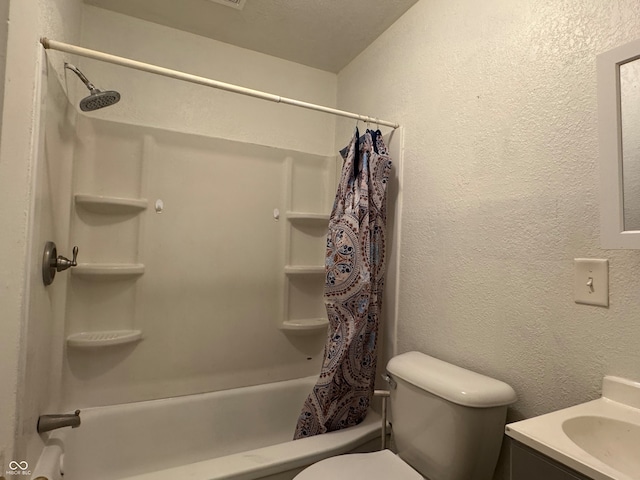 full bathroom with vanity, shower / tub combo, and toilet