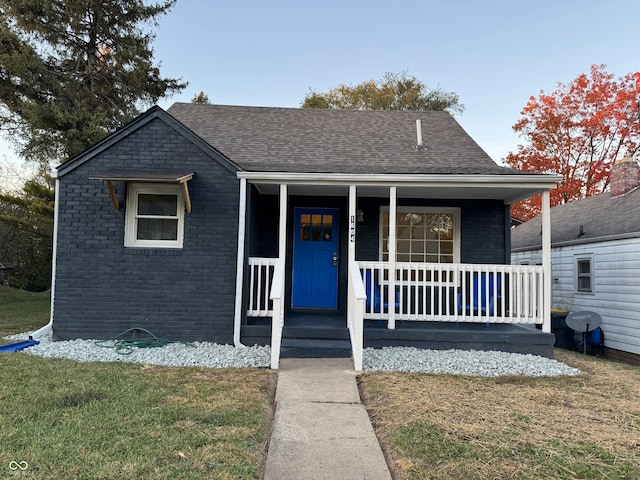 bungalow featuring a front lawn and covered porch